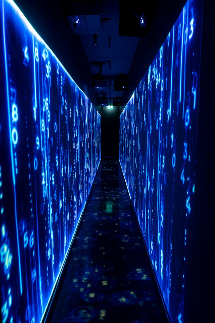 gallery-6 A luminous blue tunnel with digital numbers creating a futuristic, sci-fi ambiance.
