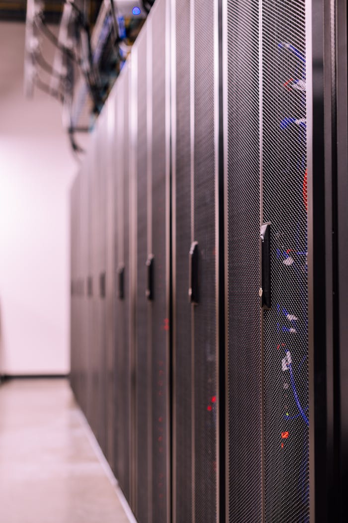 services-03 Row of similar lockers with various optic fiber cables in modern data server room